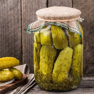 Why does a white coating appear on pickled cucumbers and is it possible to eat them?